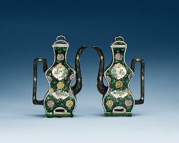 1406. A pair of famille noire ewers with covers, Qing dynasty, 18th Century.