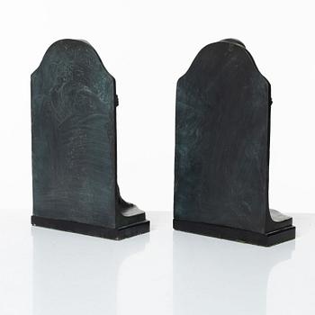 Axel Gute, a pair of patinated bronze bookends, dated 1920.