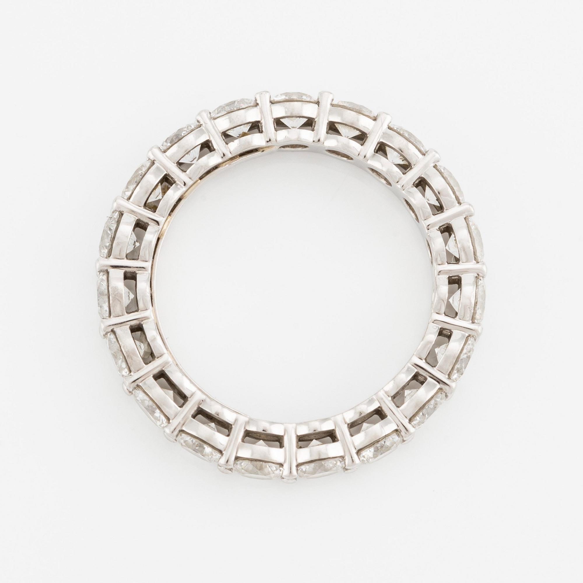 A platinum Tiffany & Co eternity ring set with round brilliant-cut diamonds.