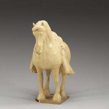 A yellow glazed pottery figure of a horze, presumably Tang dynasty (618-907).