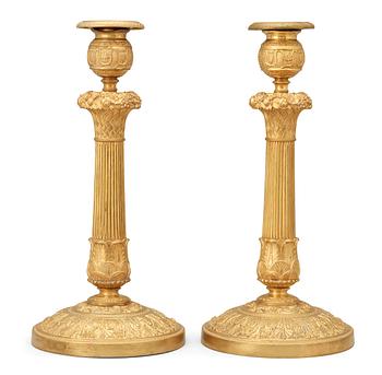 771. A pair of French Empire early 19th century candlesticks.