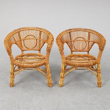 A pair of rattan chairs.