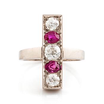 An 18K white gold ring set with faceted rubies and old-cut diamonds.