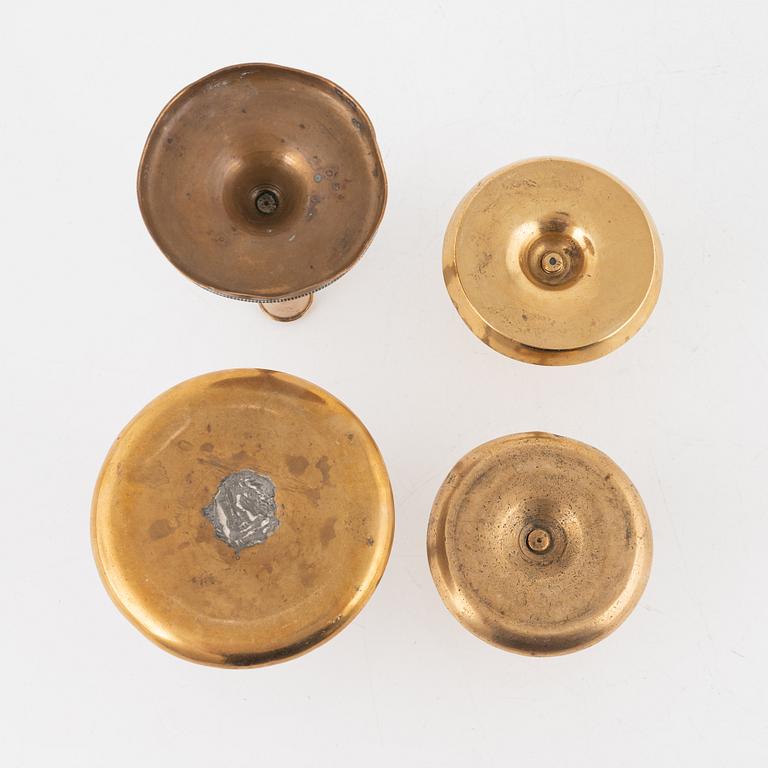 Four brass candlesticks, 18th-19th Century.