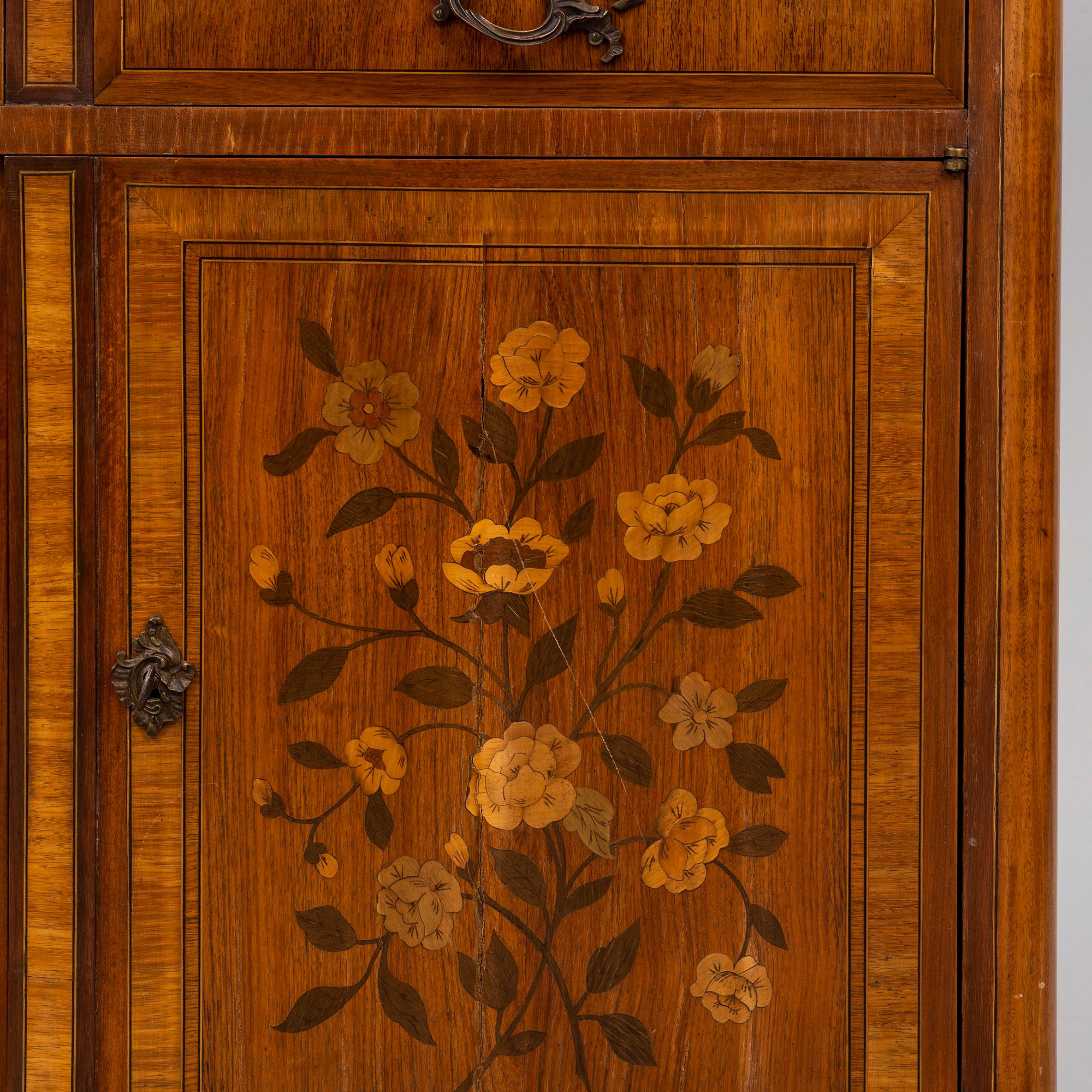 A French Louis XVI-style cupboard, ca 1900.