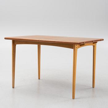 A 1960's teak and rosewood veneered dining table.