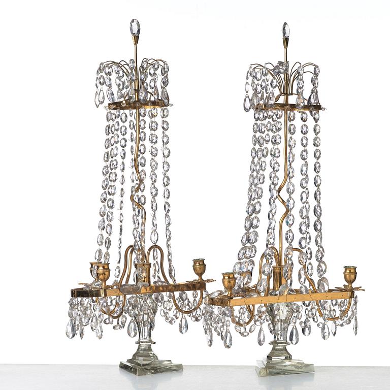 A pair of late George III late 18th century three-light table girandoles.