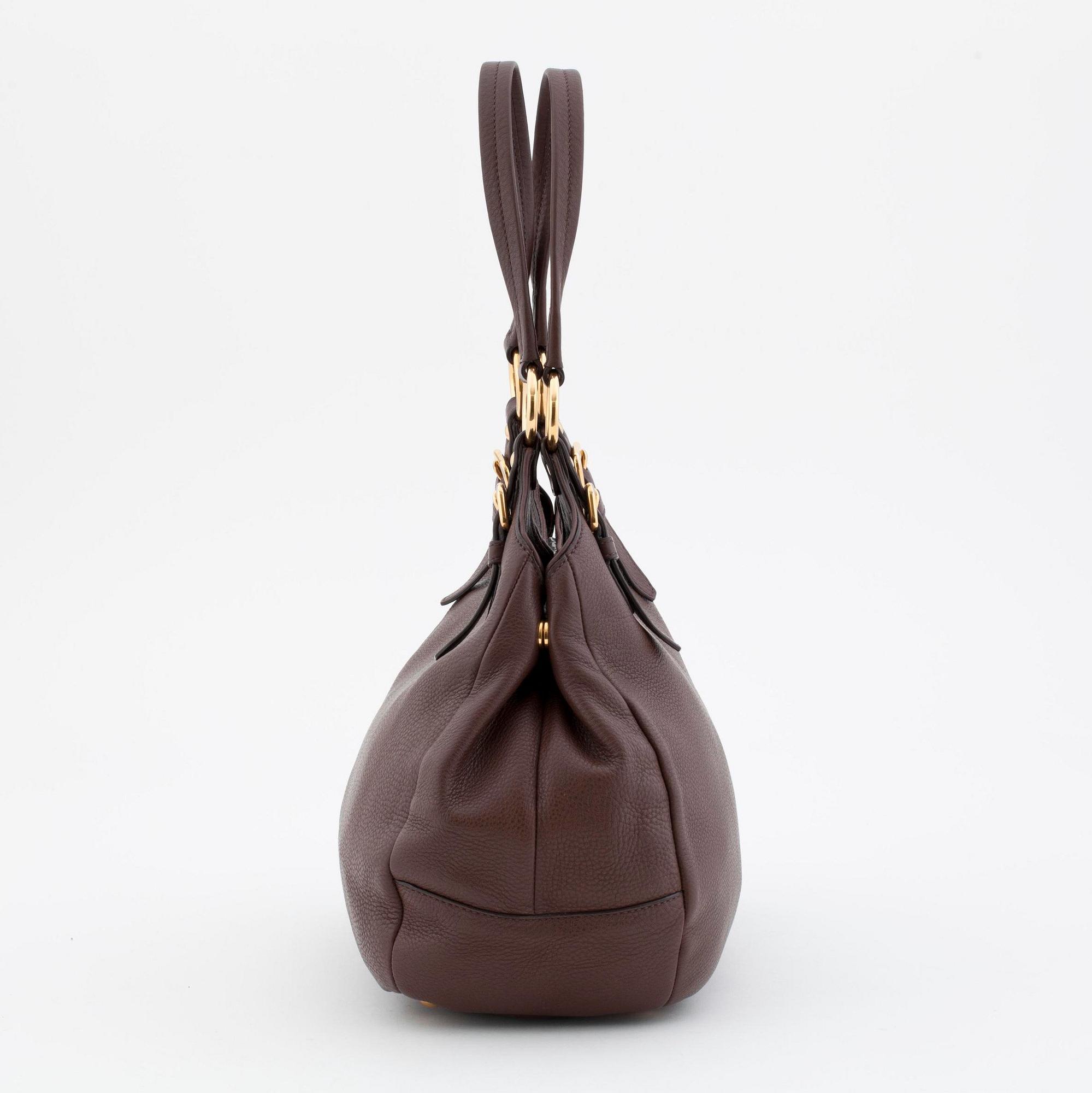 PRADA, a brown leather shoulder bag.