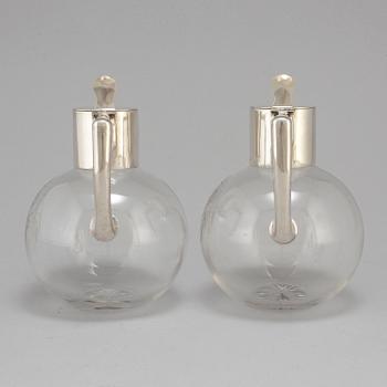 A pair of caraffes with silver mountings by CG Hallberg, Stockholm 1890.