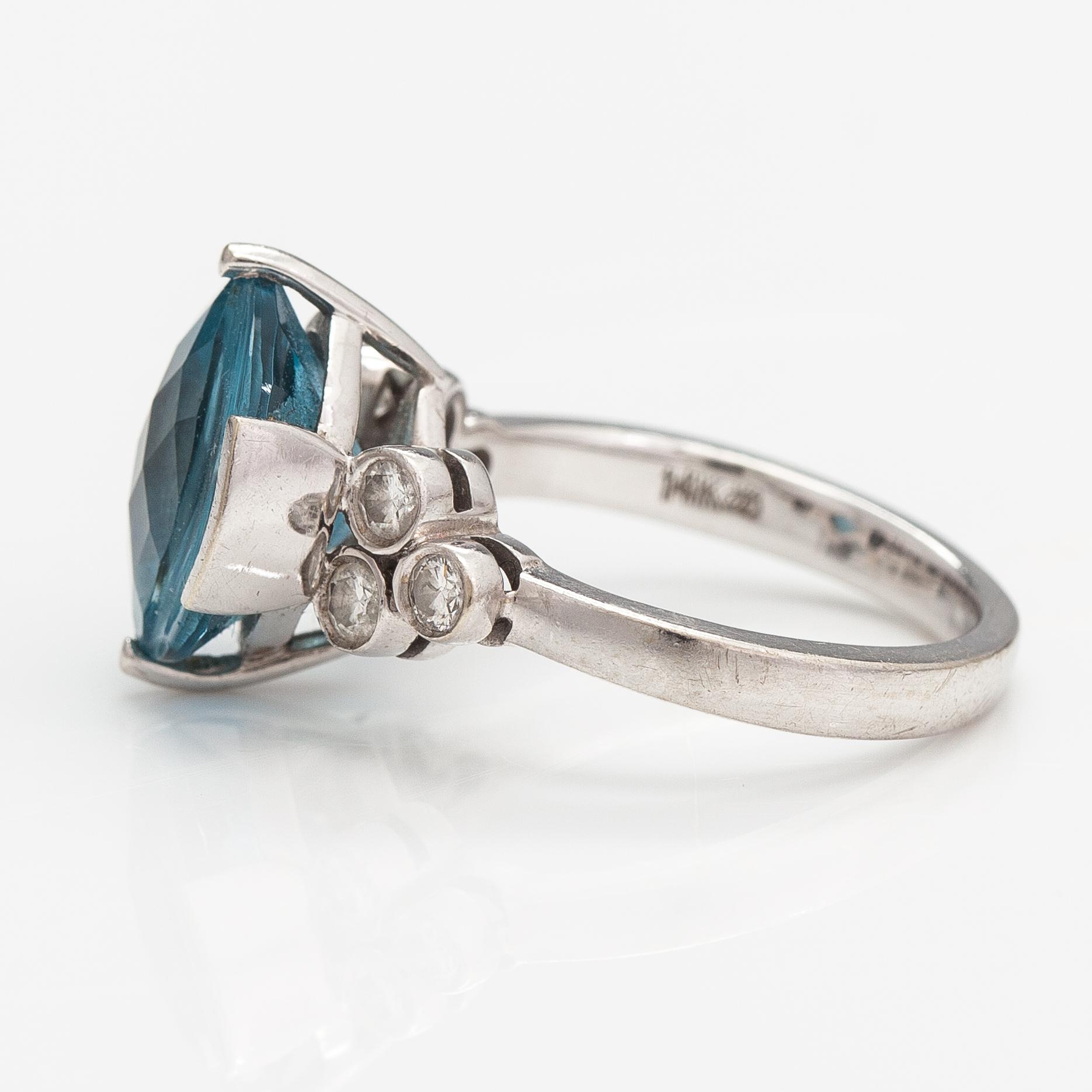 A 14K white gold ring with a topaz and diamonds ca. 0.18 ct in total.