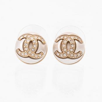 A pair of Chanel earrings.