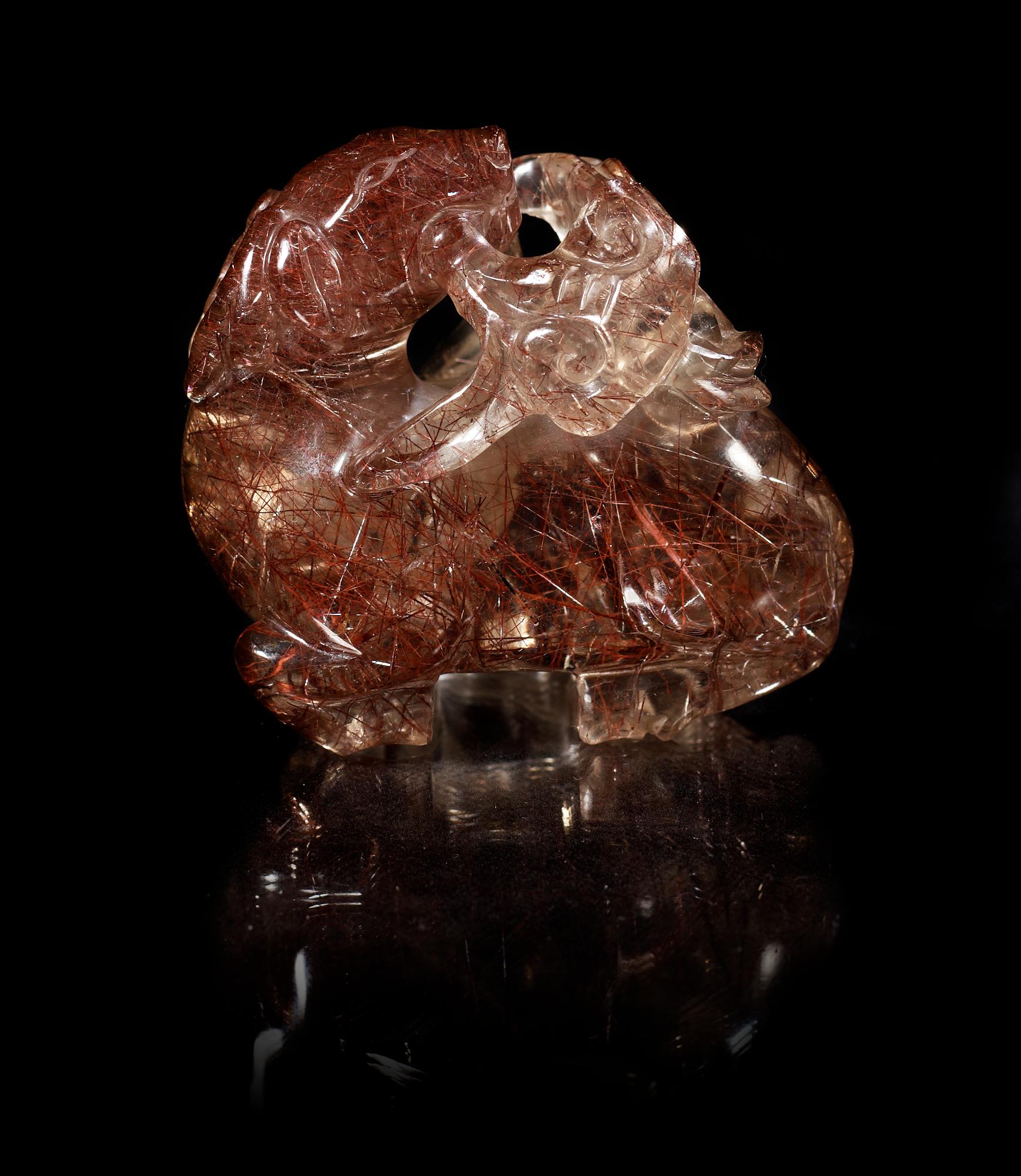 A carved quartz figure of a reclining deer with a dog and som fungus, China, early 20th Century.