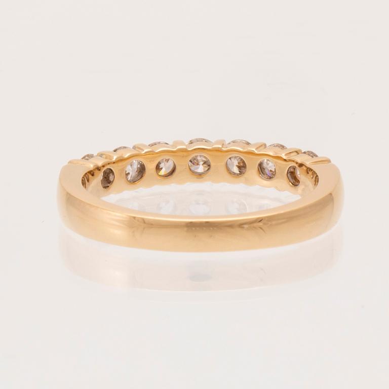 An 18K gold half-eternity ring set with round brilliant-cut diamonds.