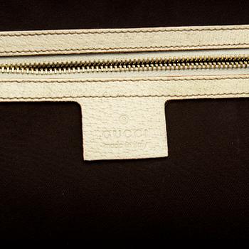 A Gucci canvas and leather hand bag.