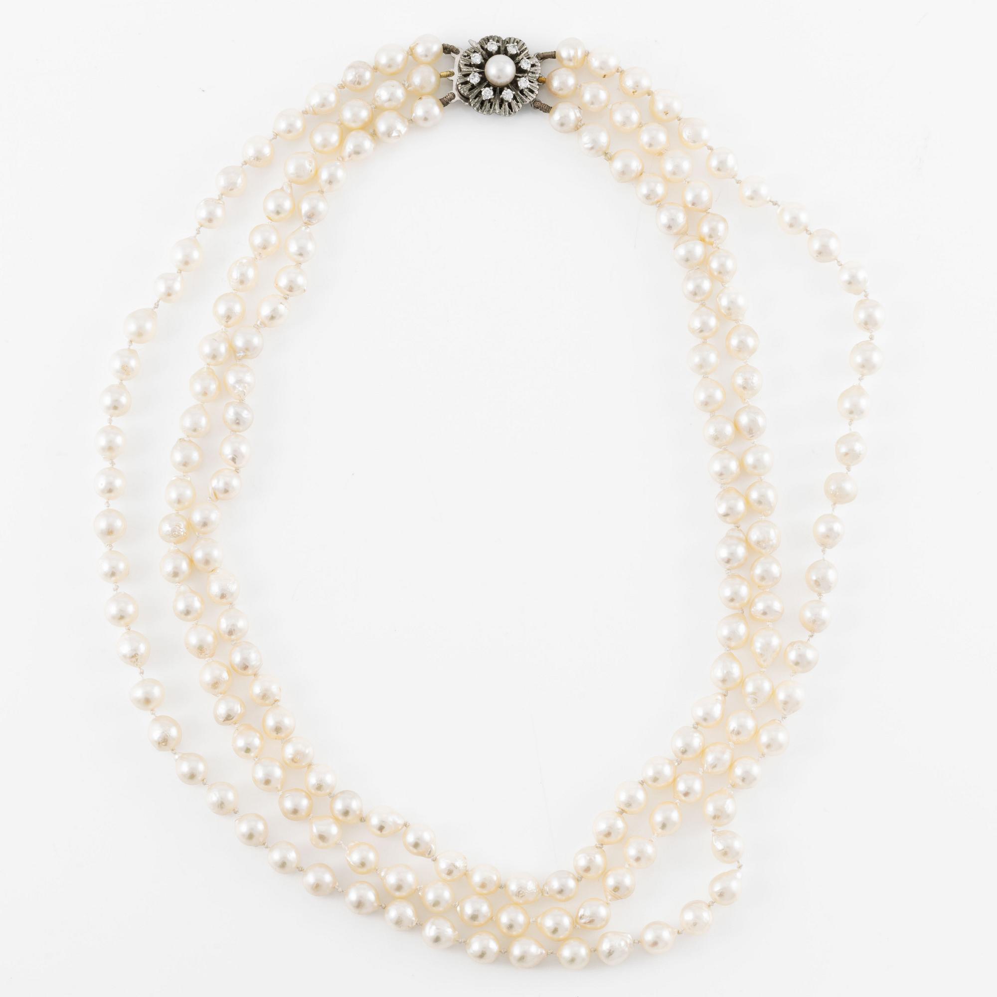 Necklace, three strands of cultured pearls, clasp in silver set with brilliant-cut diamonds.