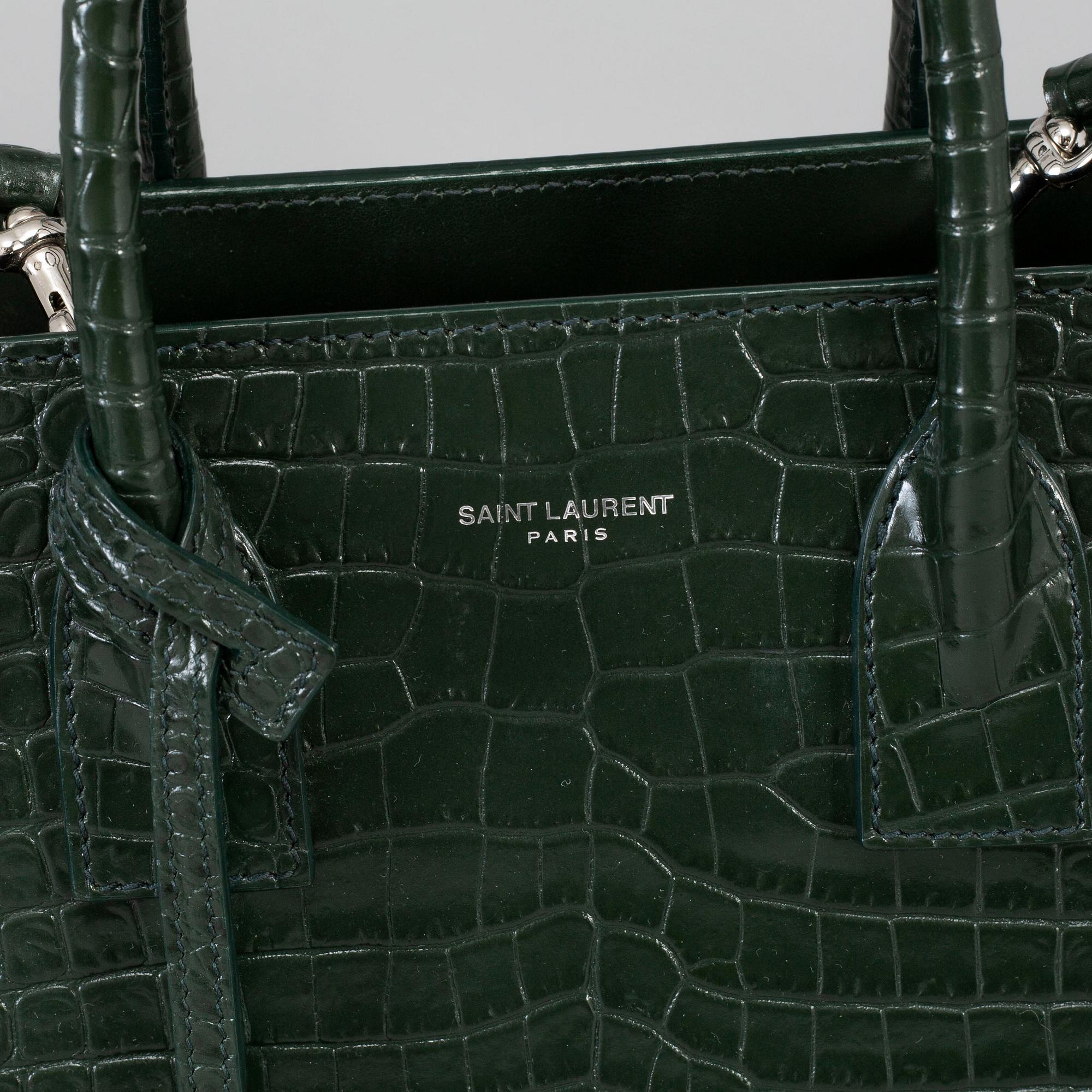 YVES SAINT LAURENT a crocodile embossed green leather Sac du Jour Baby bag 2018. Bukowskis