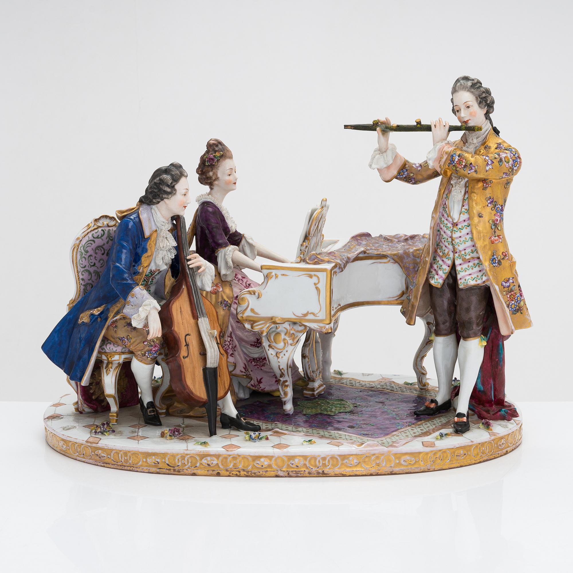 A Volkstedt porcelain musical trio figurine, mid-20th century. Length 40 cm.