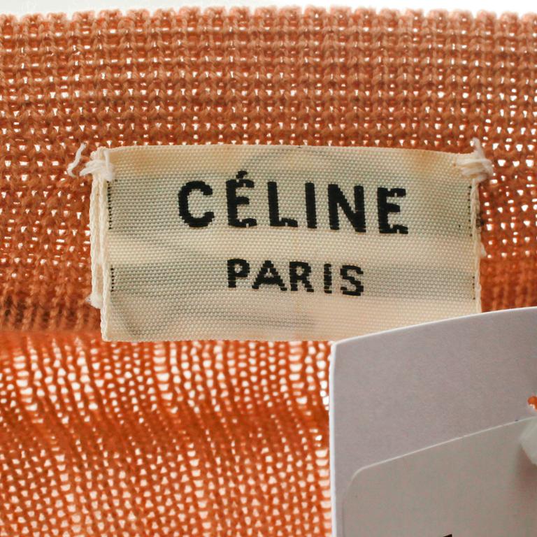 CÉLINE, a beige cardigan.