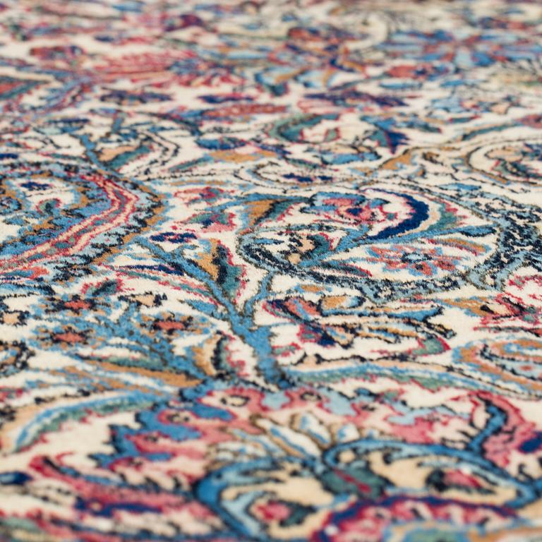 A semi-antique carpet from Kerman, 346 x 273 cm.
