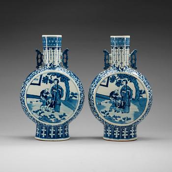 1742. A pair of large blue and white moon flasks, late Qing dynasty (1644-1912), with Kangxi four character mark.