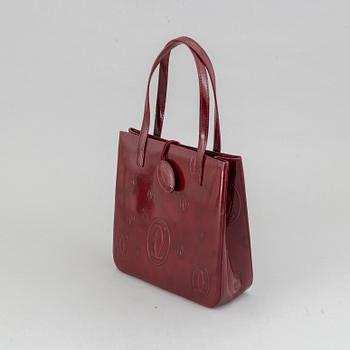 Cartier, a burgundy patent leather handbag and wallet.