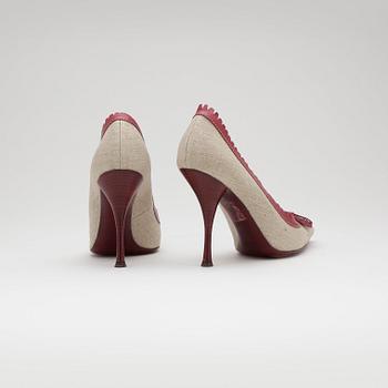 YVES SAINT LAURENT, a pair of red leather and canvas pumps.
