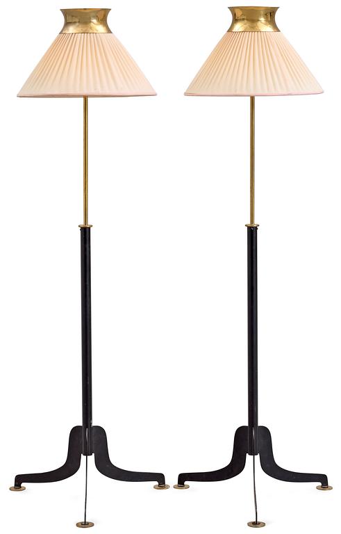 A pair of Josef Frank iron and brass floor lamps by Svenskt Tenn.