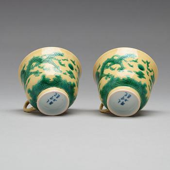 A pair of yellow glazed tea cups with stands, Qing dynasty with Guangxus six character mark (1875-1908).