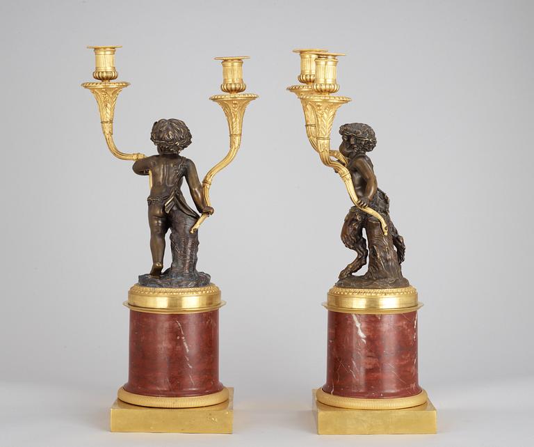 A pair of Louis XVI-style 19th century gilt and patinated bronze and red marble two-light candelabra.