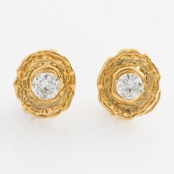 A pair of 18K gold earrings set with round brilliant-cut diamonds.