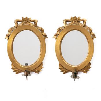 A pair of mirror girandoles for one candle, late 19th century, Gustavian style.