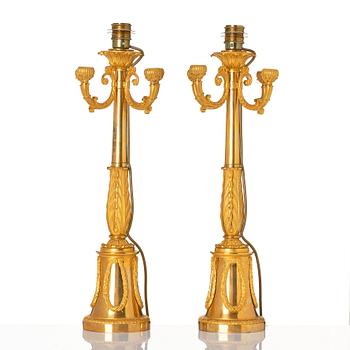 A pair of French Empire four-light candelabra (lamps), early 19th century.