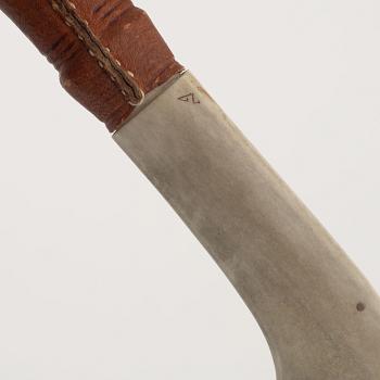 A reindeer horn knife, signed.