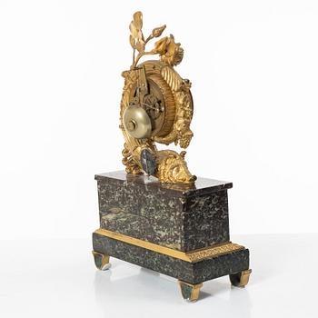 A presumably French Empire-style gilt bronze and marble mantel clock, later part 19th century.
