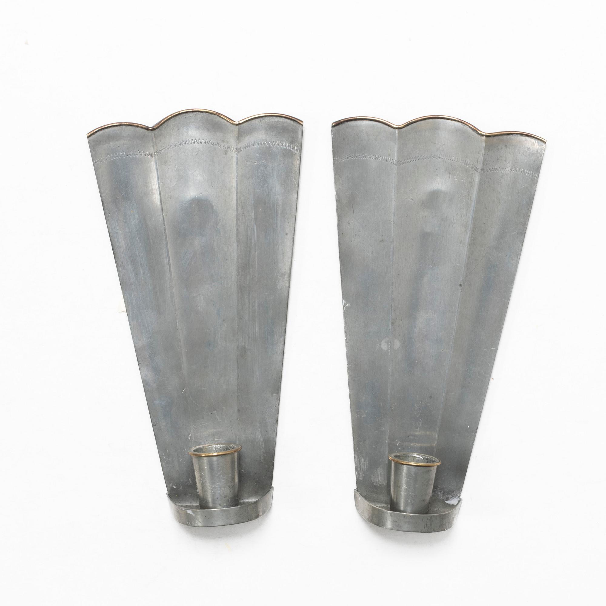 Nils Fougstedt, a matched pair of pewter and brass wall sconces, model A 60, Svenskt Tenn, Stockholm 1929 and 1932.