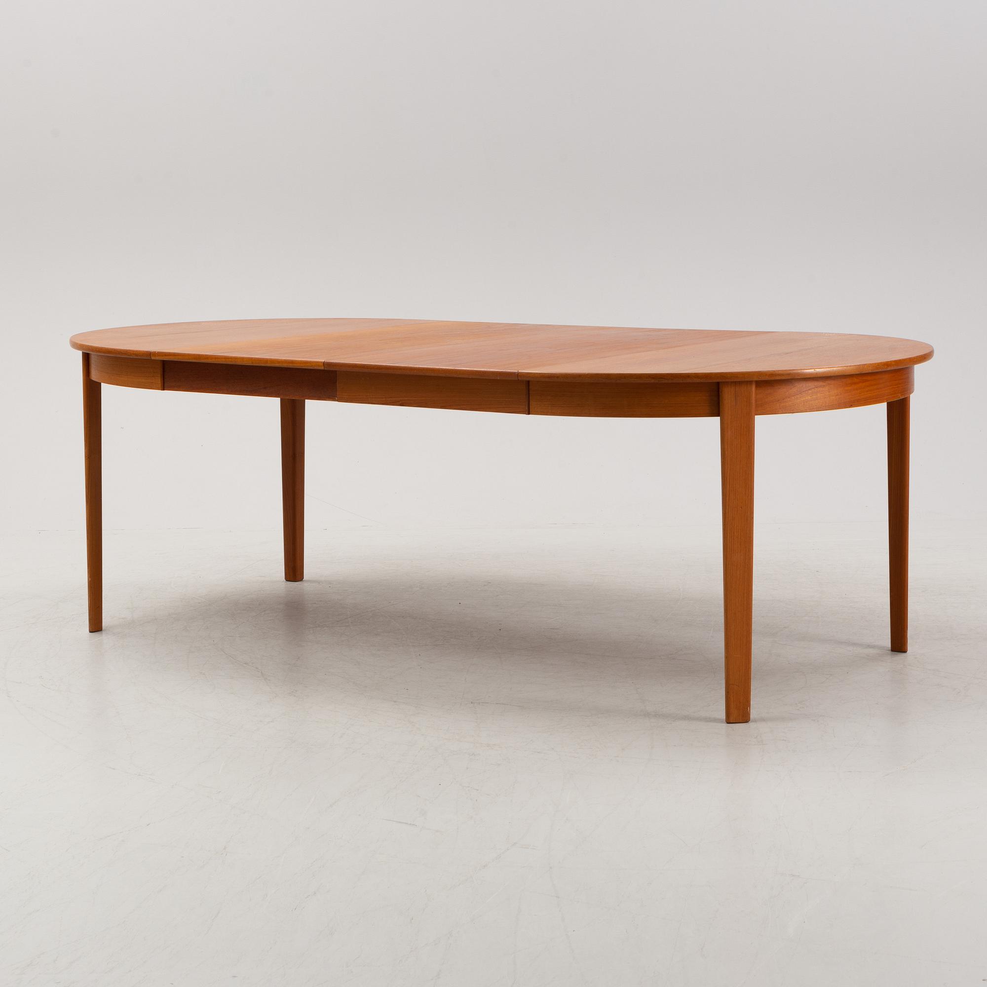 A 1950's/60's teak-veneered dining table.