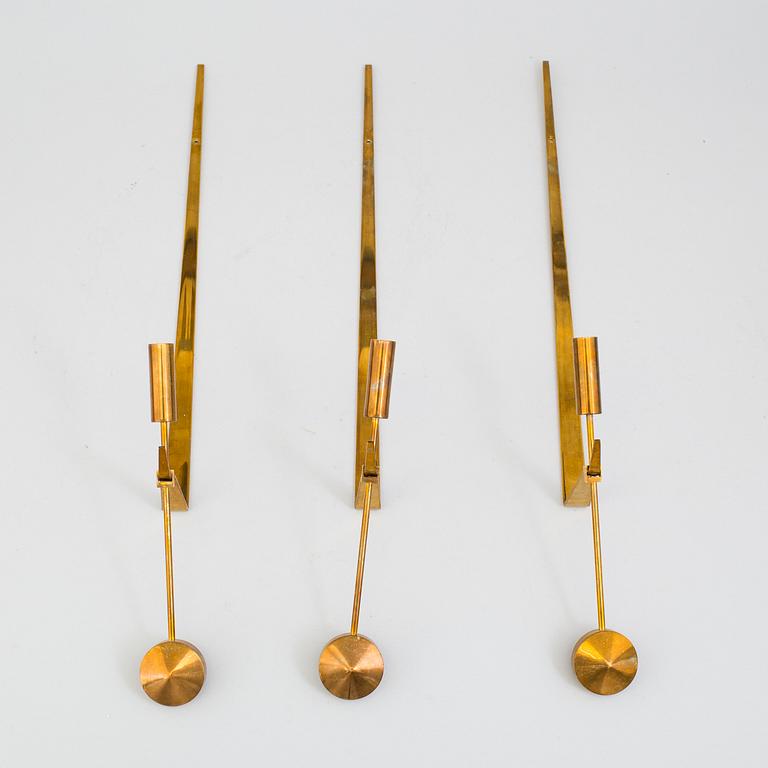 PIERRE FORSSELL,  three 'Pendeln' brass wall sconces from Skultuna.