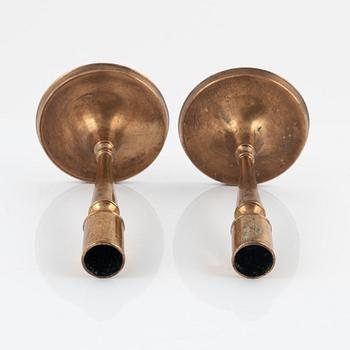 A pair of bronze candlesticks, 18th Century.