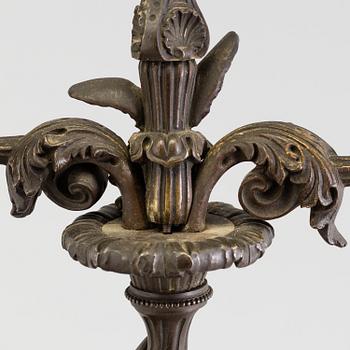 A pair of late 19th century patinated brass candelabra.