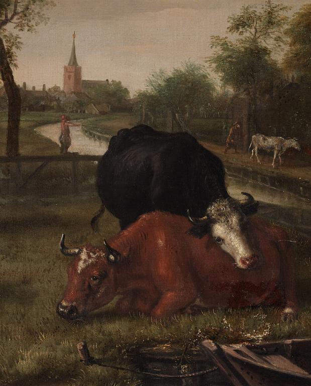 Jan Victors Attributed to, A meadow Landscape with a boy in a punt with cows nearby, a village beyond.