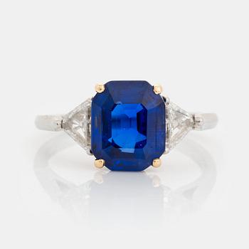 435. A platinum and 18K gold ring set with a faceted sapphire.