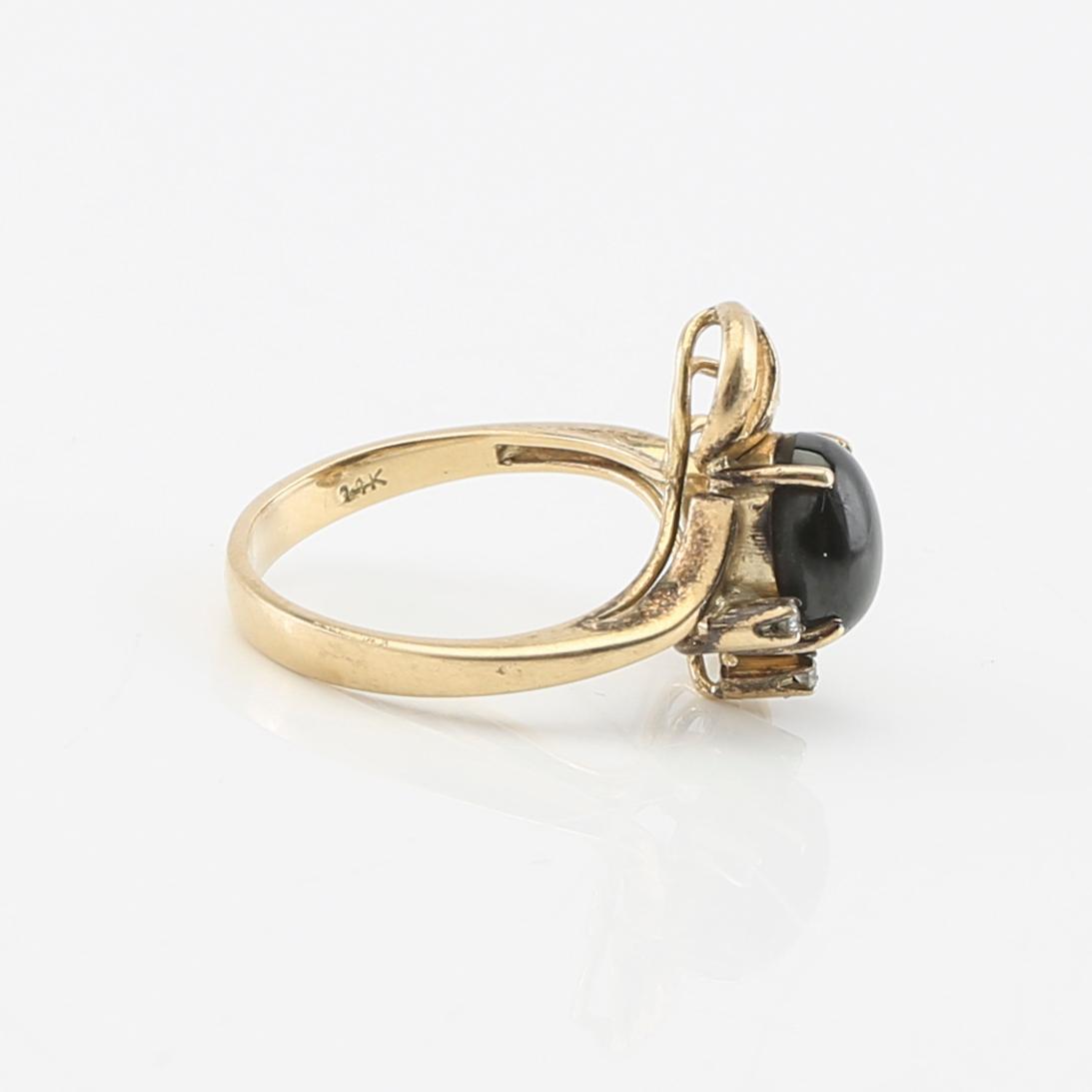 Ring and earrings in 14K gold with round brilliant-cut diamonds and likely natural black star sapphires.