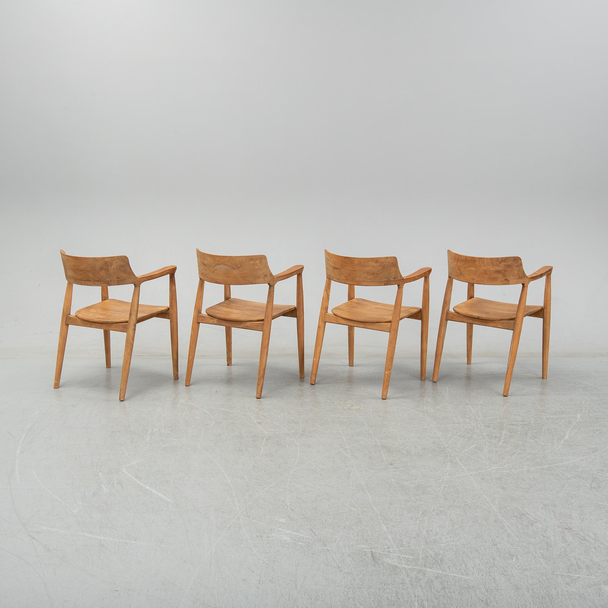 Four contemporary teak armchairs.