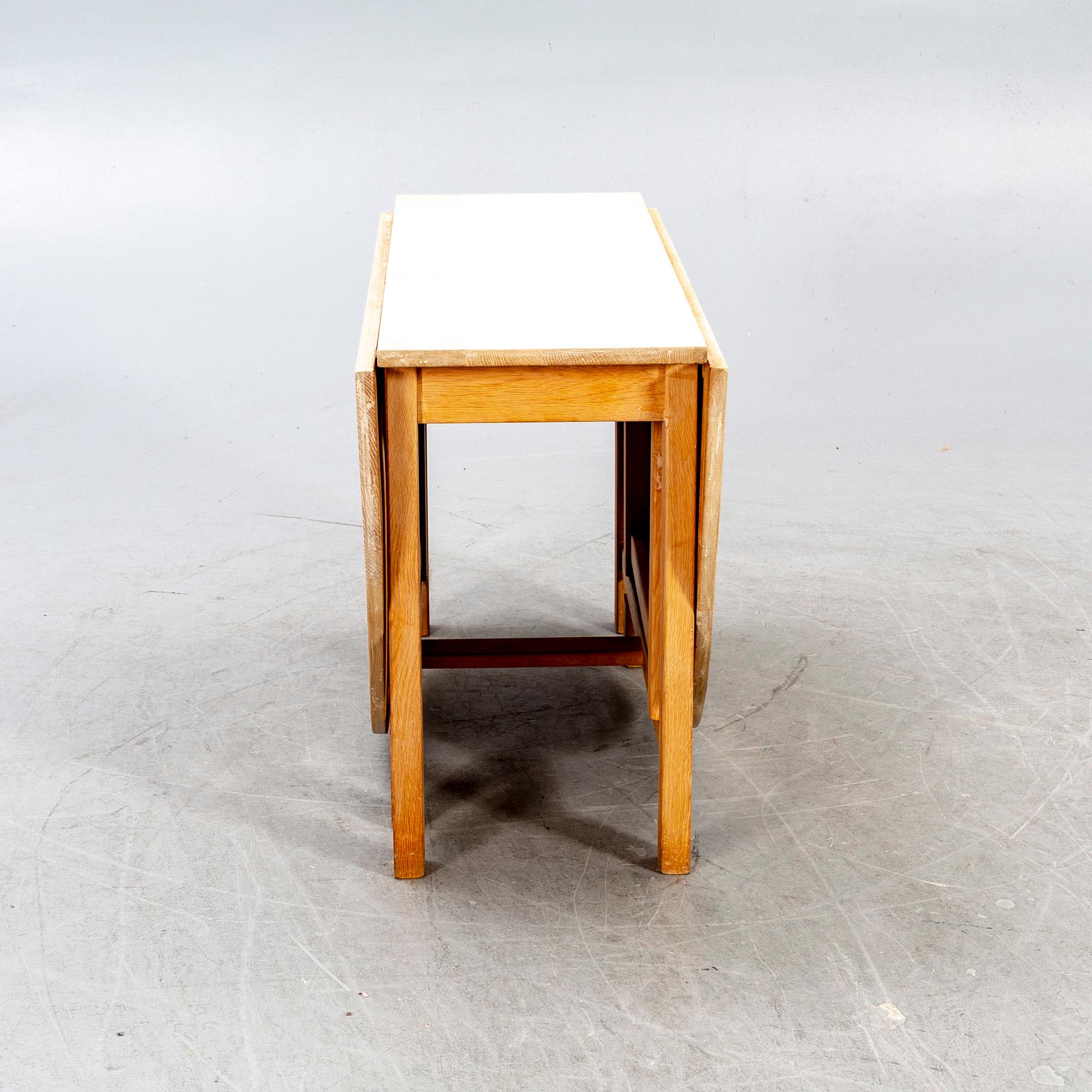 A 20th century oak folding table.
