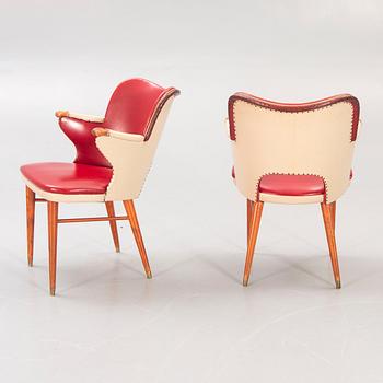 A pair of 1950s armchairs.