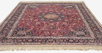 A semi-antique Mashad carpet, signed Saber, c. 401 x 300 cm.