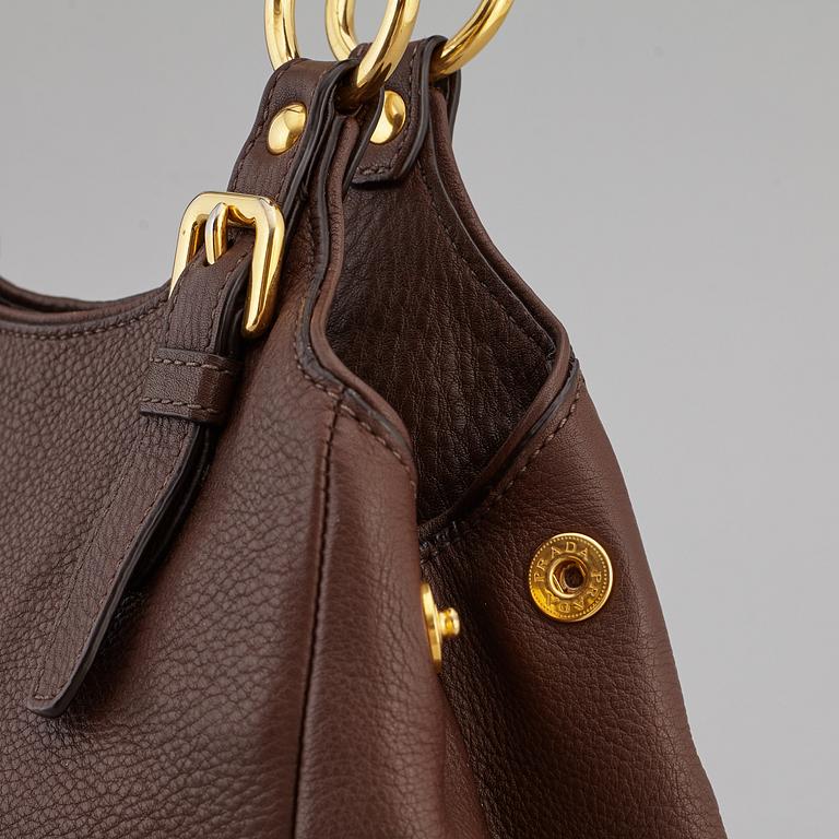 PRADA, a brown leather bag.