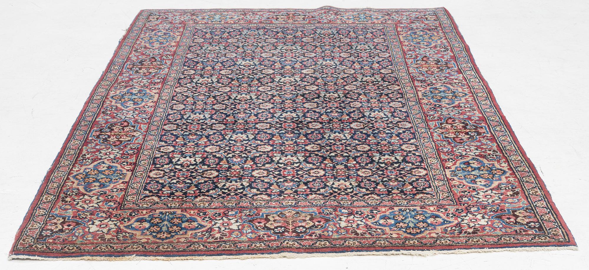 A rug, probably Meshed, semi-antique, c. 180 x 125 cm.
