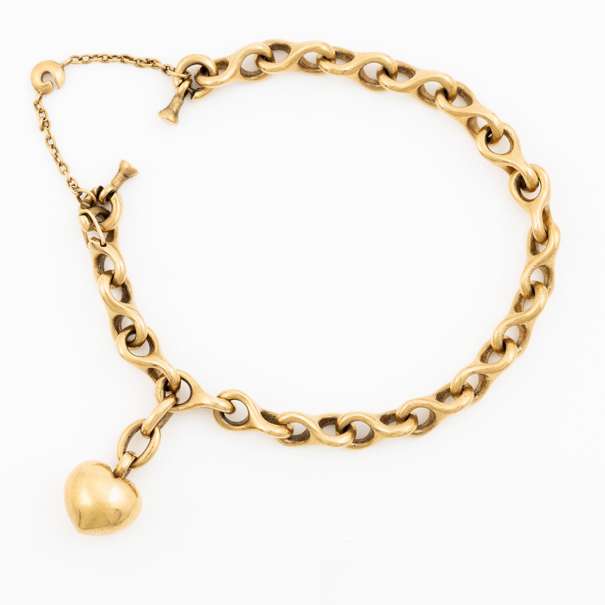 An Ole Lynggaard bracelet 18K gold with heart charm.