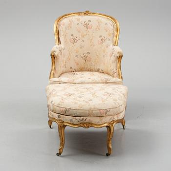 A Louis XV-style bergère armchair with stool, second half of the 19th century.